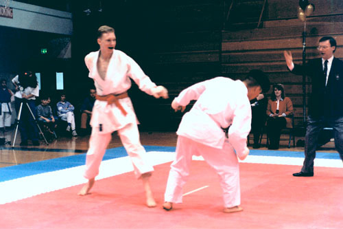 Photo of kumite match with two young men.